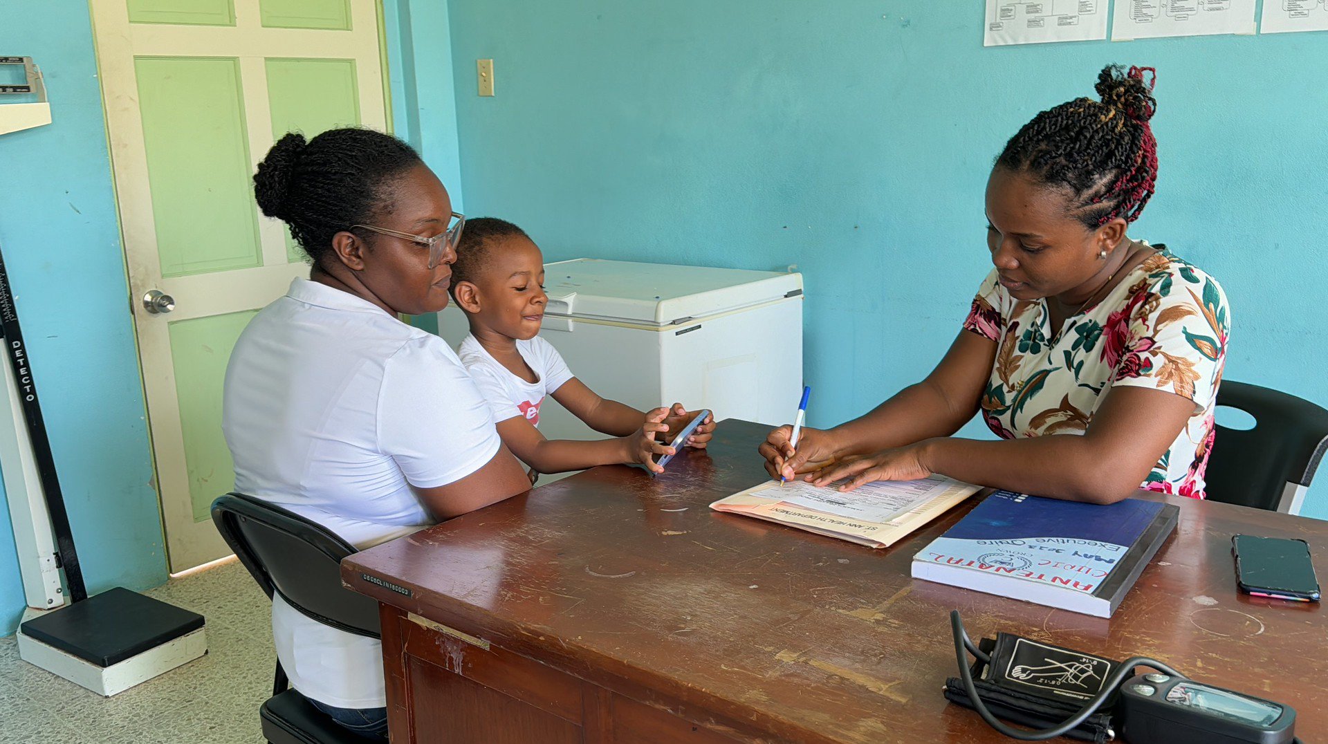 Health worker attending mother in Jamaica