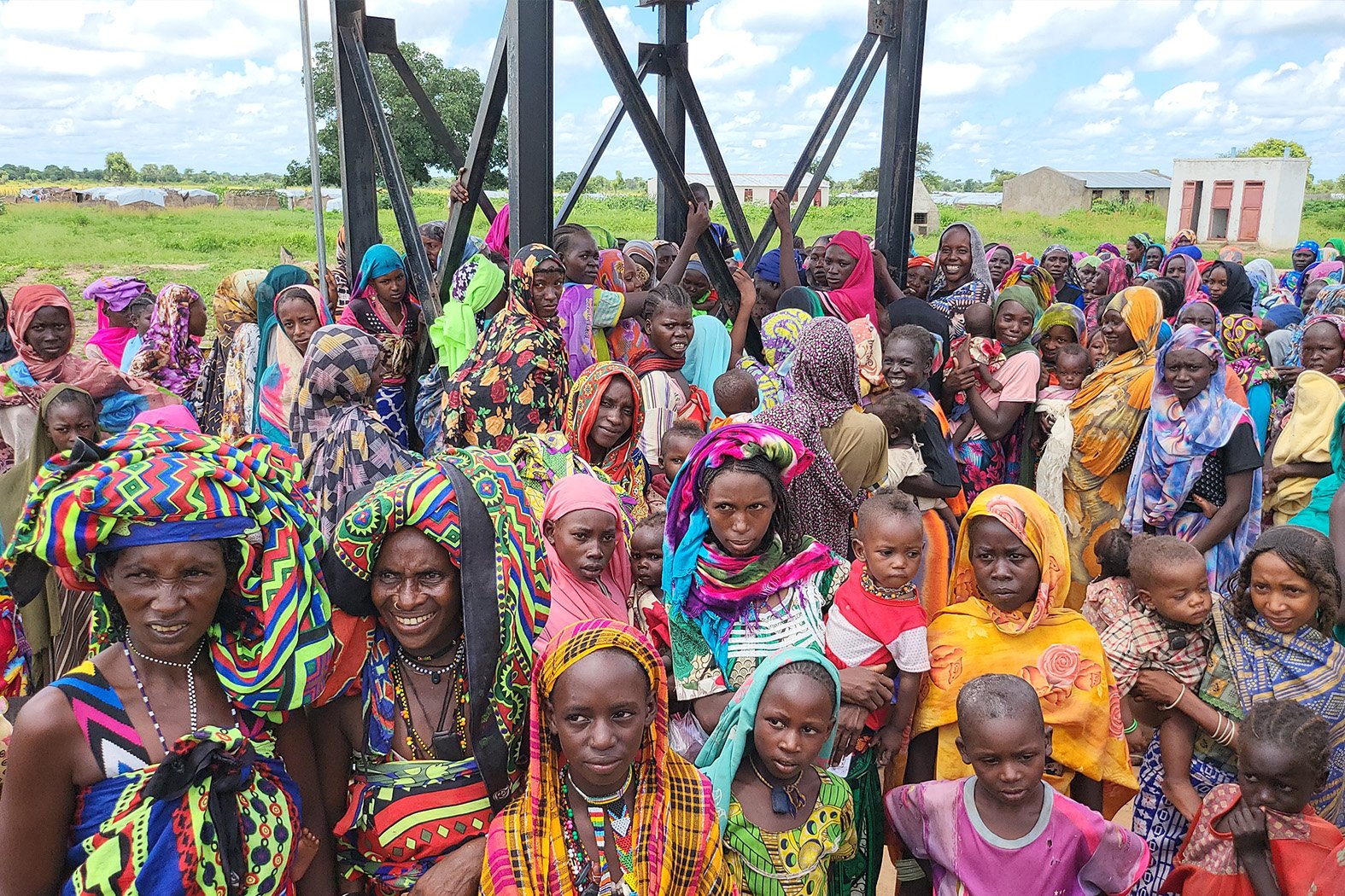 Women and children during the guinea worm disease sensitization in Alradom Refugee Camp, South Darfur, 2022.
